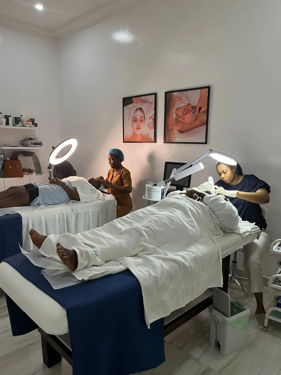 Estheticians performing facial treatments on clients at Beth Beauty Aesthetic Institute's training environment
